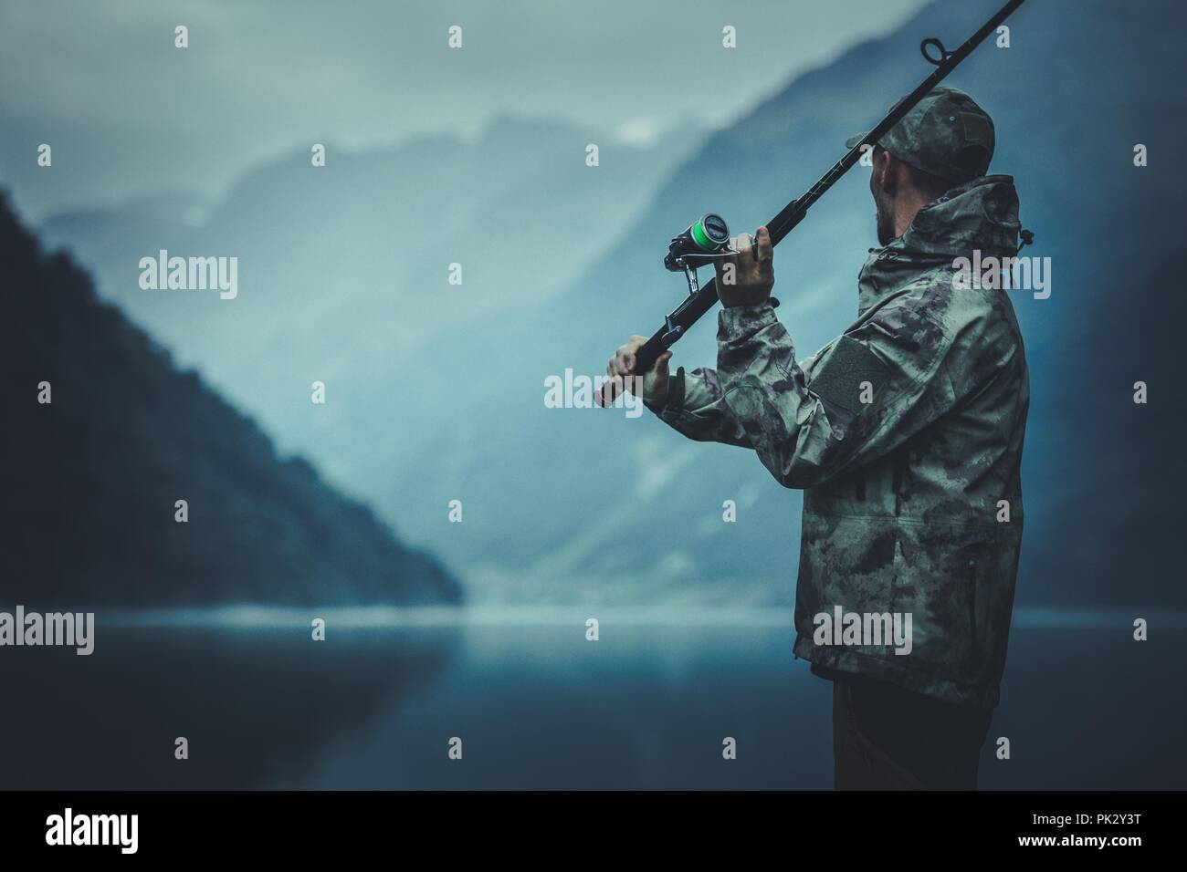 Evening Fly Fishing Time. Caucasian Fisherman with Fishing Rod on the