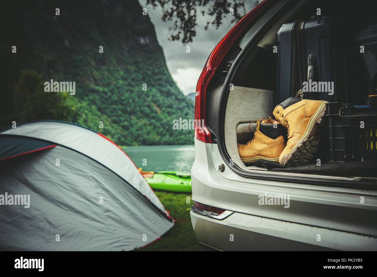 Road Trip with Tent Camping in the Norway. Scenic Campsite on the Glacial Lake Shore. Stock Photo