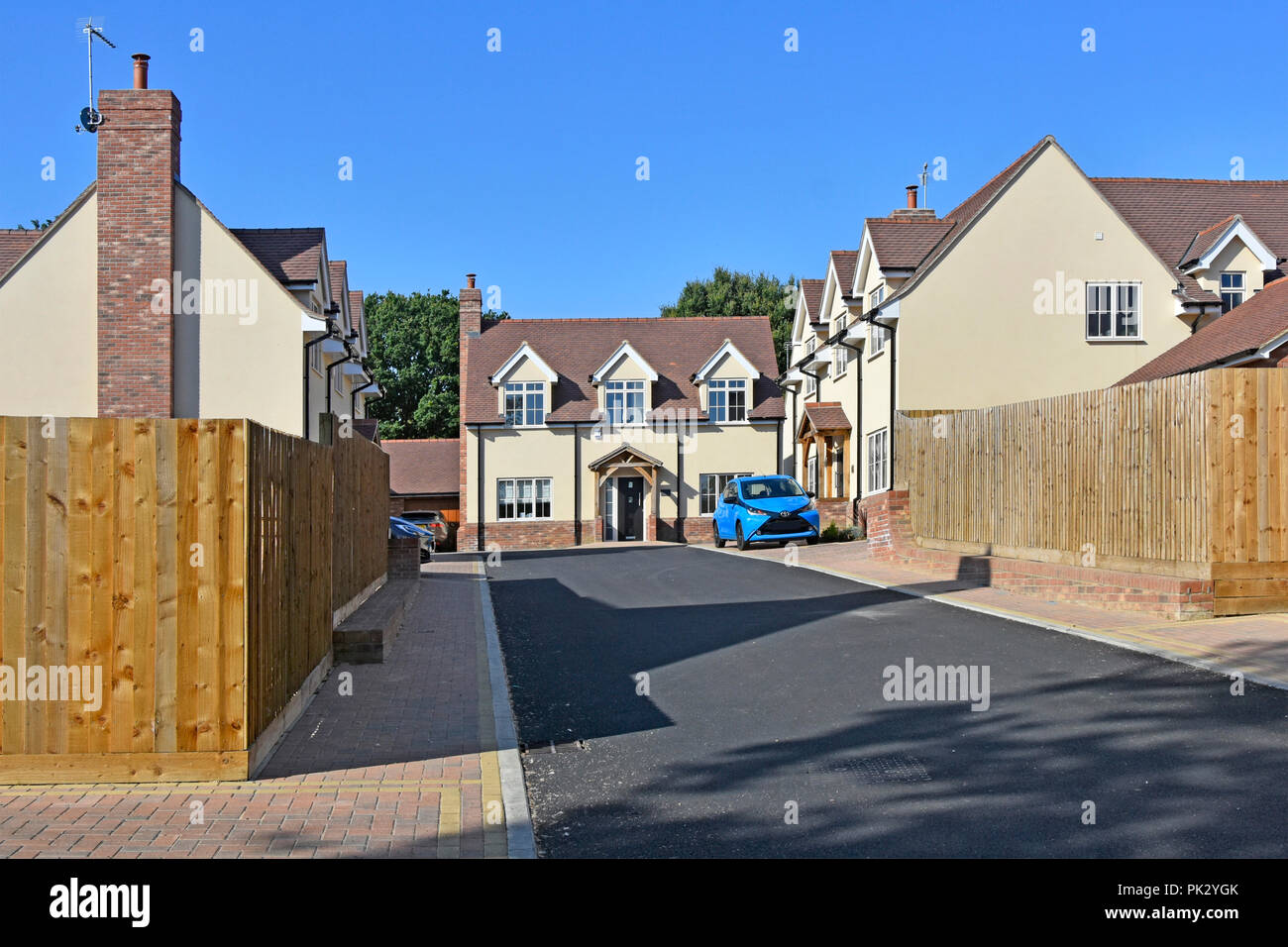 New home in housing property development mixed types real estate with tarmac service road garden fence & car parking space Essex England UK Stock Photo