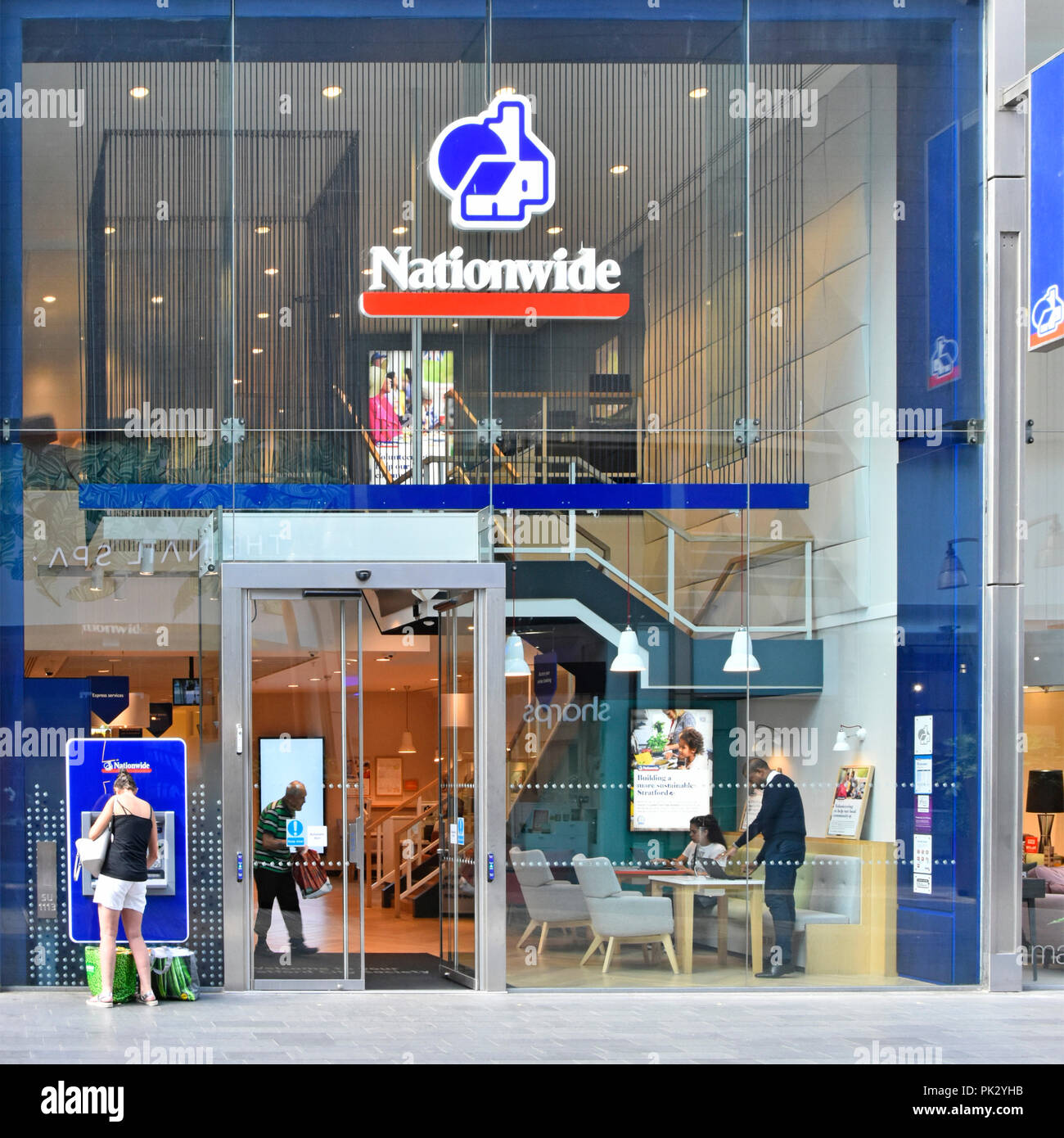 Glass front wall Nationwide building society premises & logo ATM in shopping mall at Westfield shopping centre Stratford City Newham East London UK Stock Photo