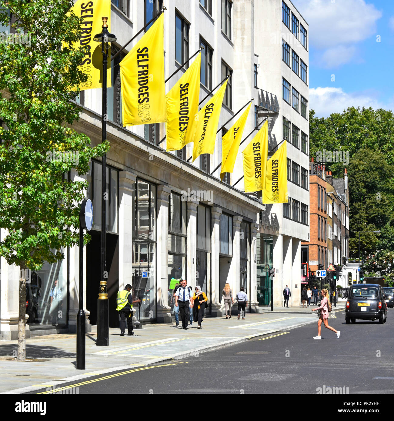 Selfridges department store yellow banners above Duke Street annex building behind famous Oxford Street West End London shopping area England UK Stock Photo