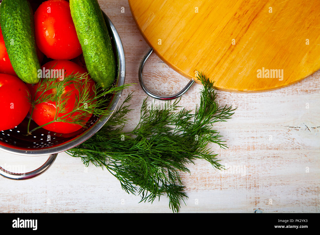 Vegetables for salad, knife and cutting board on the table. Preparation