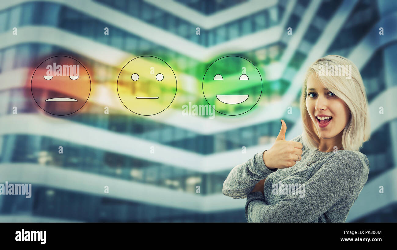 Сheerful girl smiling show thumb up like gesture choosing happy face emoticon feedback. Excellent customer service rating concept. Satisfied client sy Stock Photo