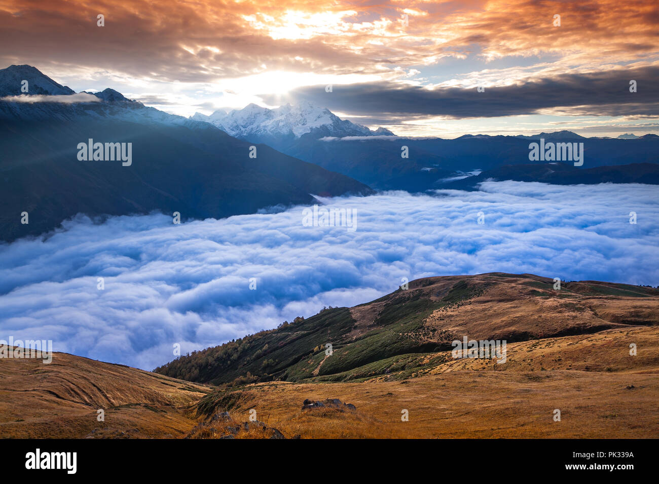 Foggy autumn morning in the Caucasus mountain. Colorful sunrise in Upper Svaneti, Georgia, Europe. October 2015. Stock Photo