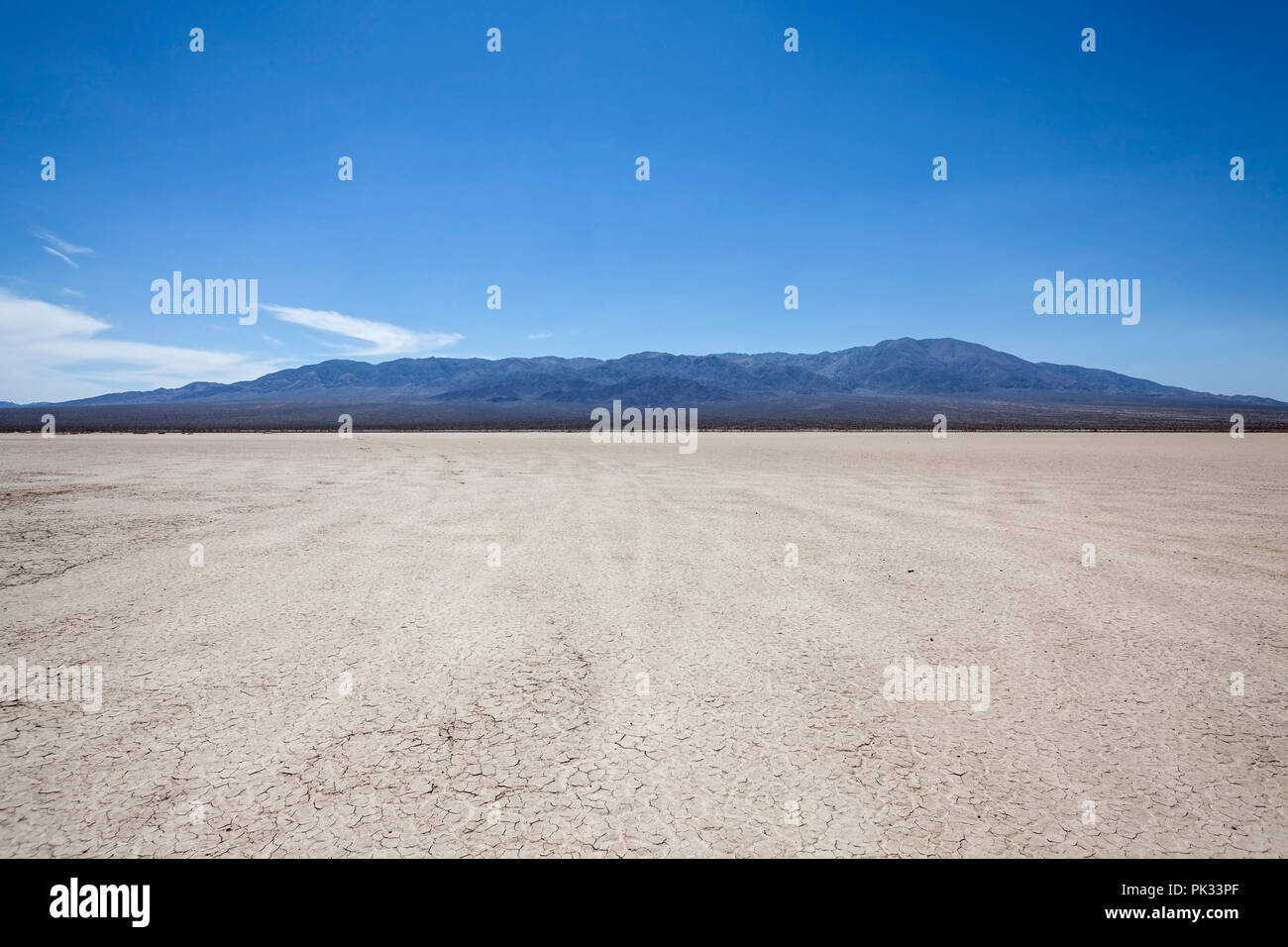 Mojave desert dry lake with mountain backdrop near Death Valley in California. Stock Photo