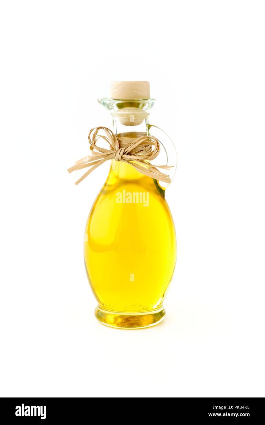 Extra virgin olive oil in a beautiful glass bottle decorated with a bow on white background. Stock Photo