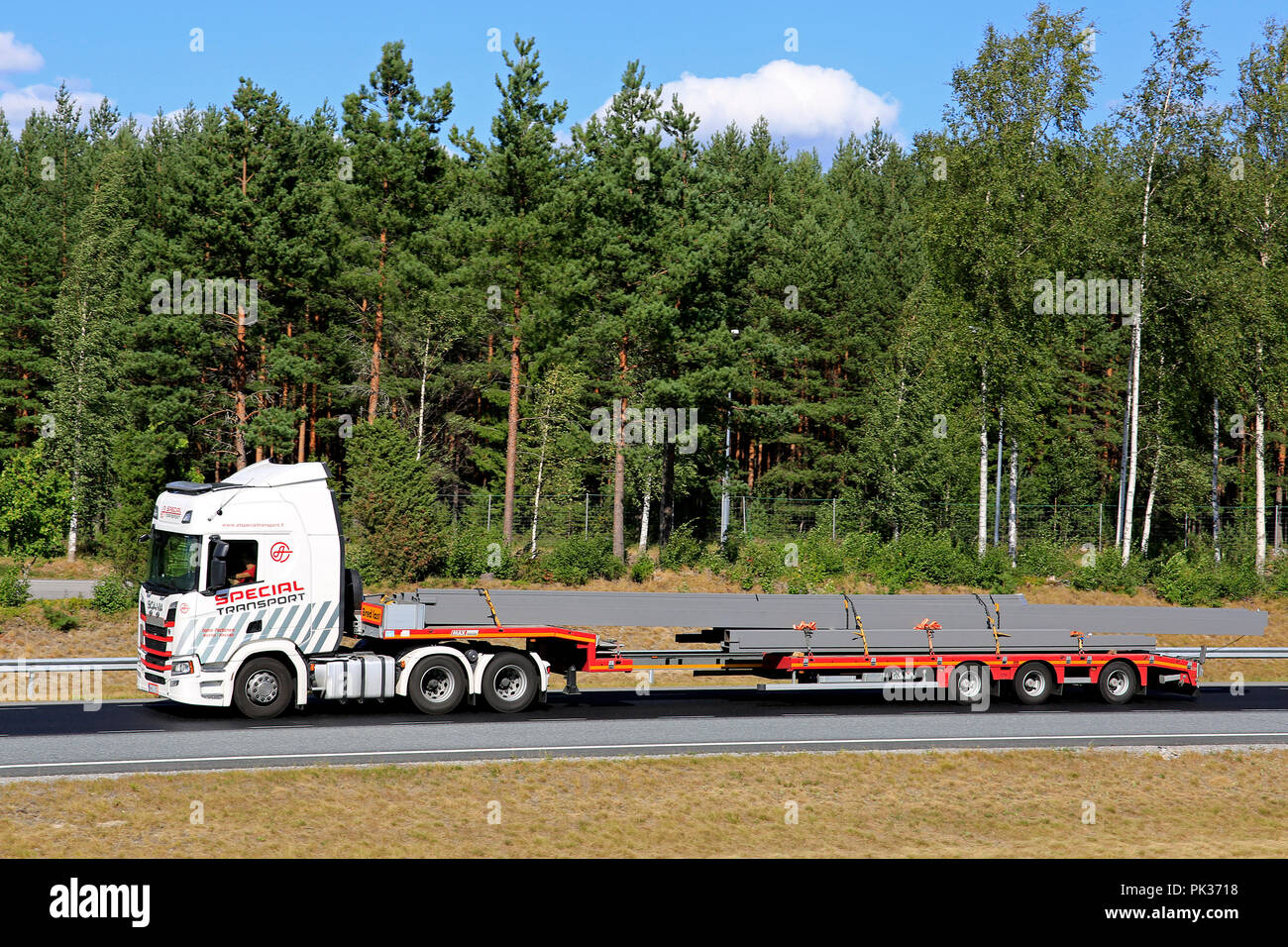 Next Generation Scania R500 of Ismo Partanen for AT Special Transport hauls oversize long load on motorway, side view. Salo, Finland - August 3, 2018. Stock Photo
