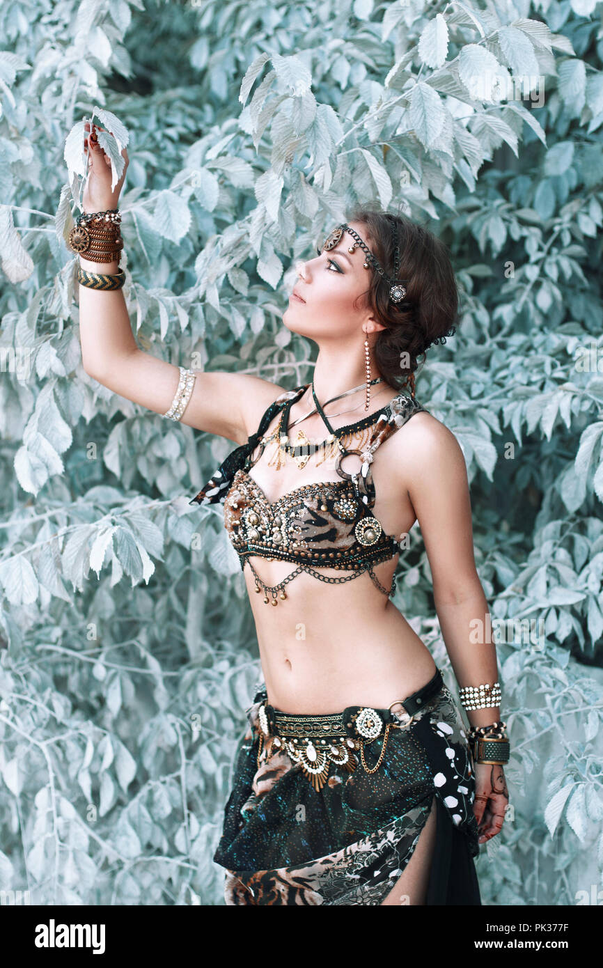 Pretty woman in tribal fusion costume near the beautiful white fairy tree. Stock Photo