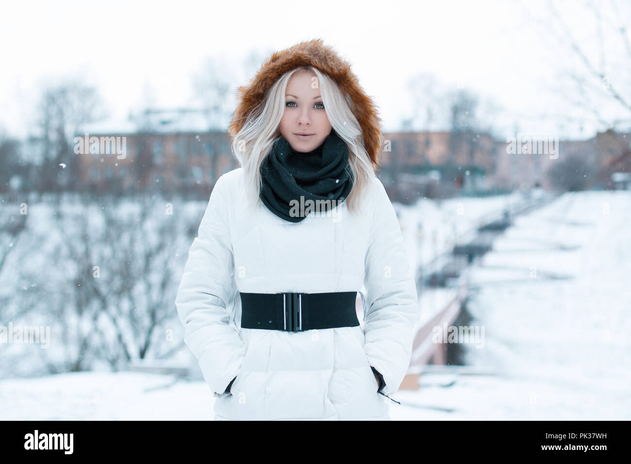 Beautiful girl in a winter jacket in the park Stock Photo - Alamy