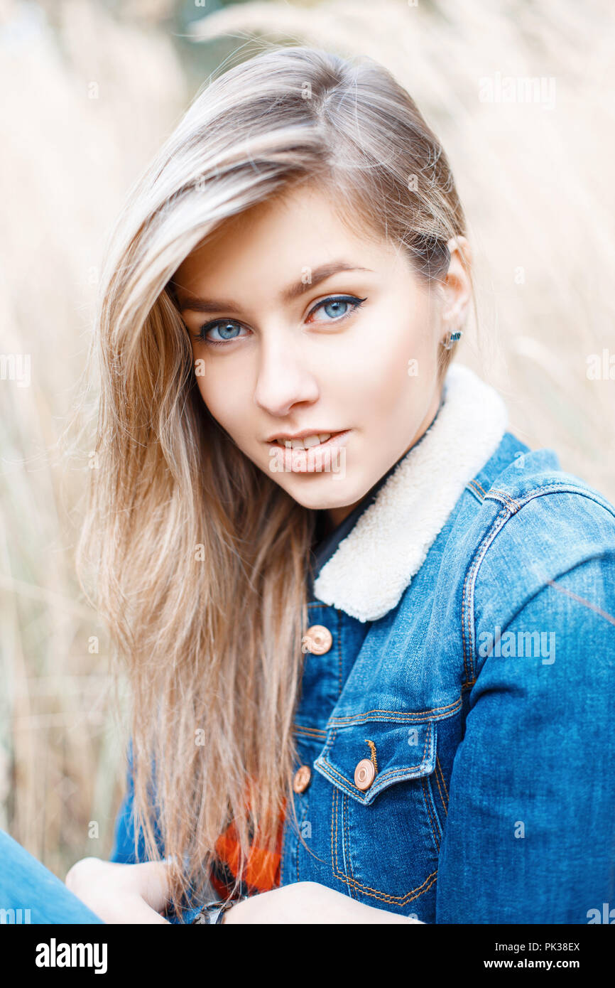 Cute girl smiling in jeans jacket with fur Stock Photo Alamy