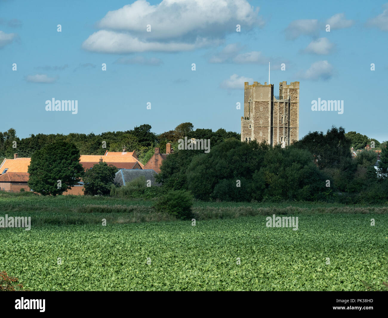 Orford castle viewed from the banks of the river Alde of farmland Stock Photo