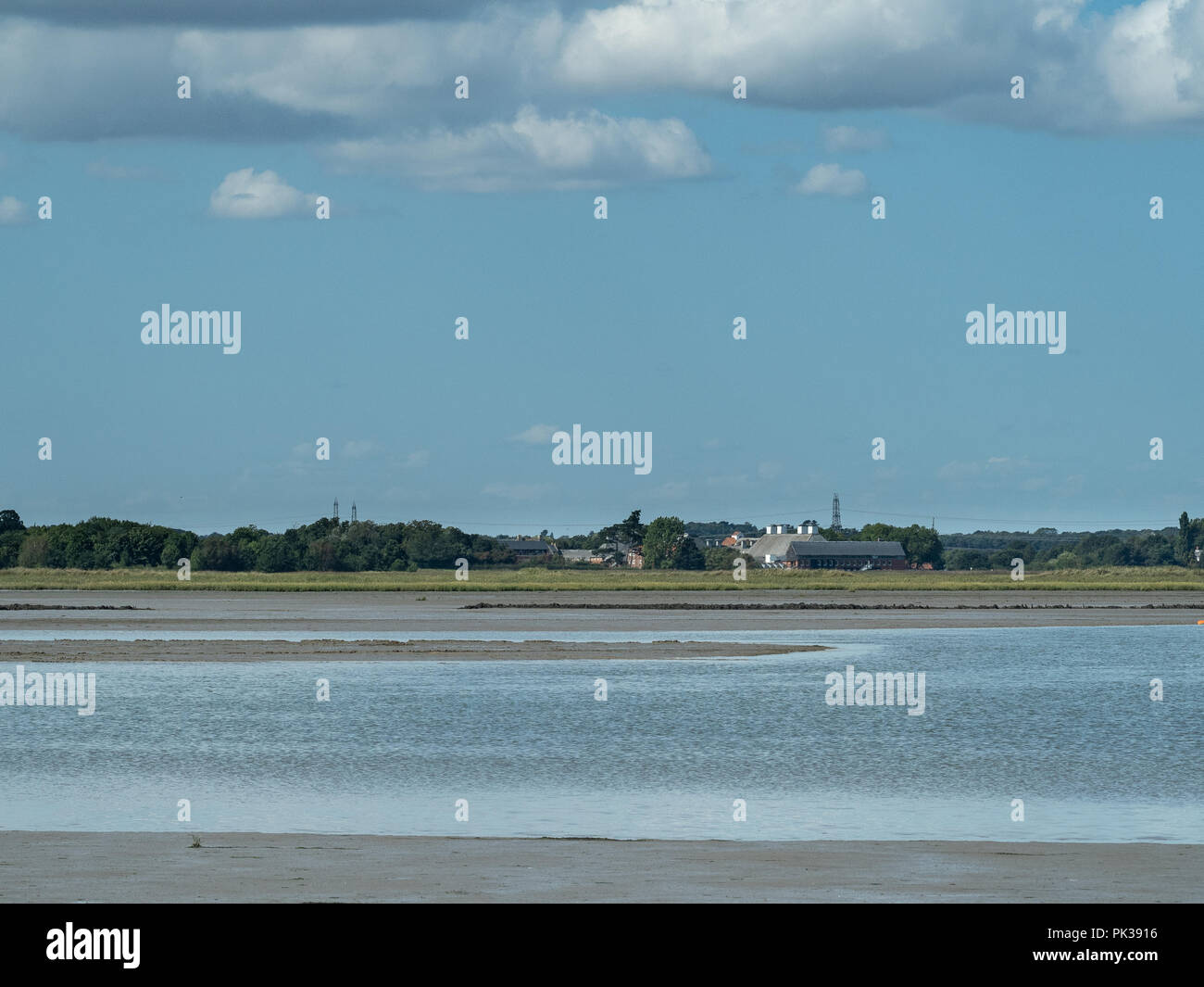 Scenic view over the river Alde at Iken showing Snape and the Snape Maltings concert hall in the distance Stock Photo