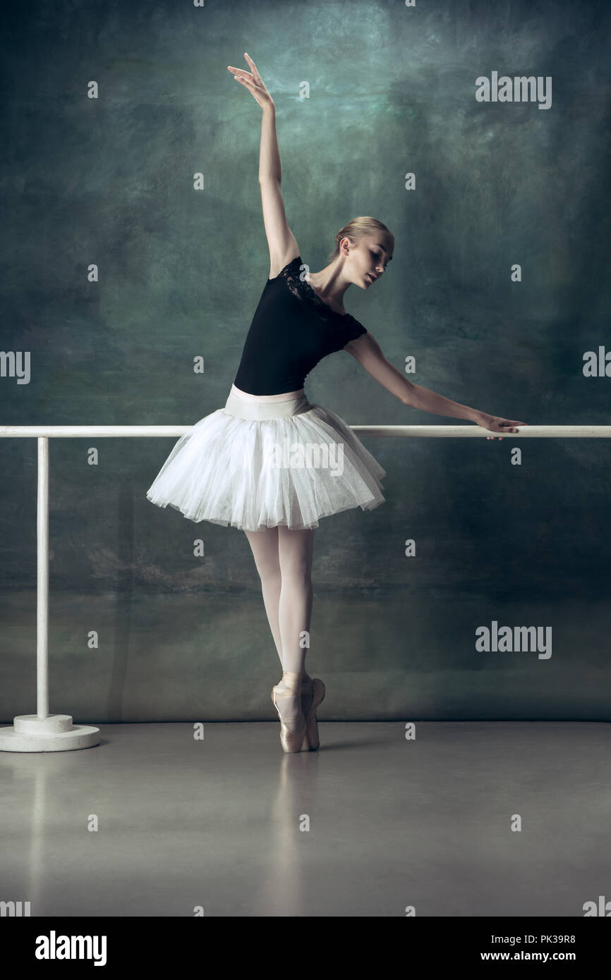 young Classical Ballet dancer in studio is standing on tiptoe.young  beautiful graceful caucasian ballerina practice ballet positions in tutu  skirt of Stock Photo - Alamy