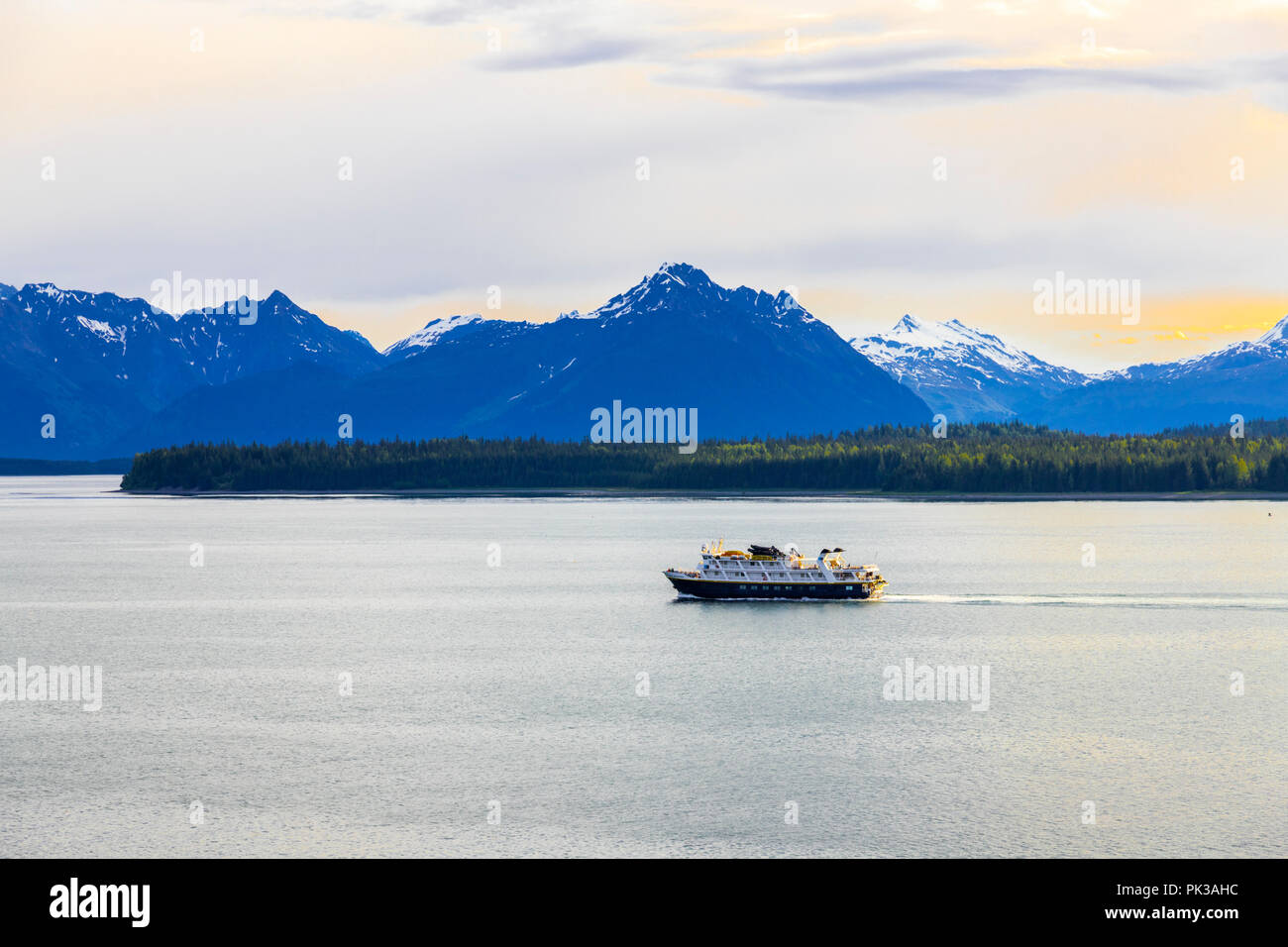 The National Geographic tour ship 'Sea Lion' at dawn in the entrance to Glacier Bay, Alaska, USA - Viewed from a cruise ship sailing the Inside Passag Stock Photo