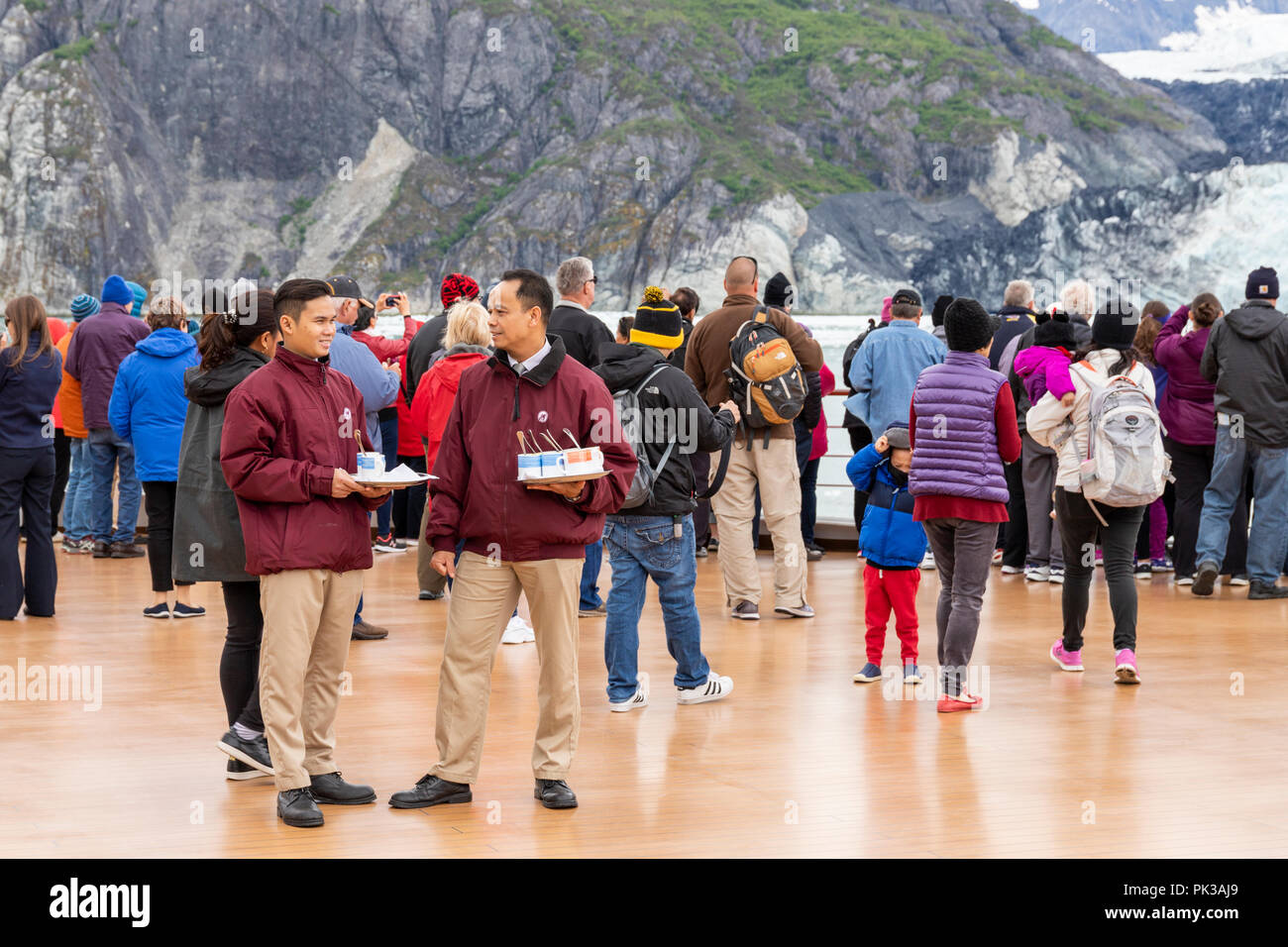 Stewards serving hot soup to passengers on board Holland America Line Cruises 'Nieuw Amsterdam' enjoying a close view of the Margerie Glacier in the T Stock Photo