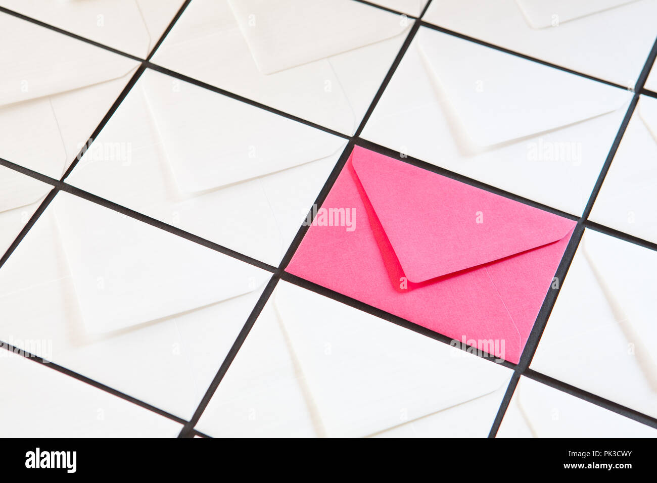 Composition with white and pink envelopes on the table. Different colored envelopes on the table. Stock Photo