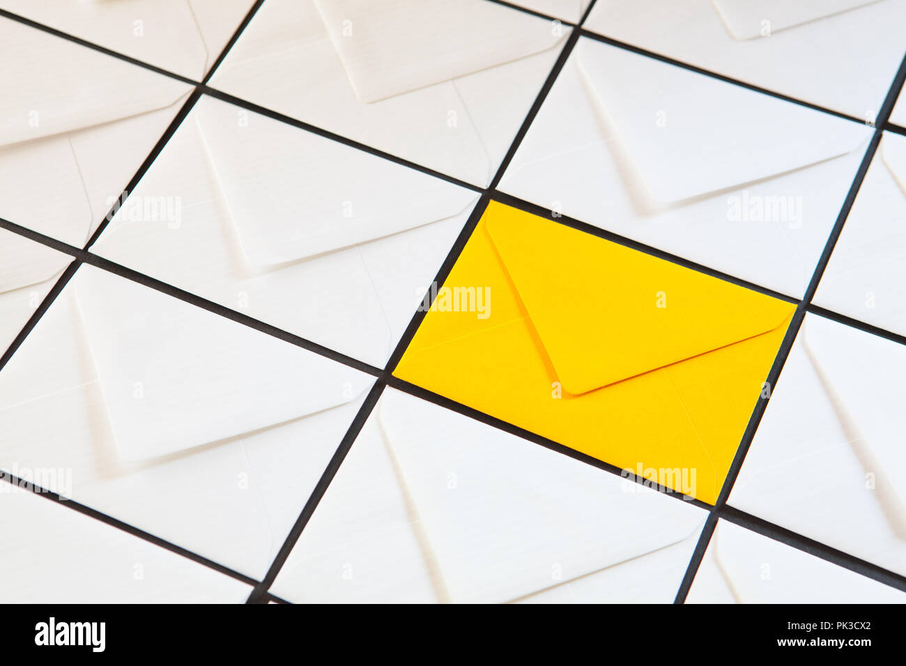 Composition with white and yellow, envelopes on the table. Different colored envelopes on the table. Stock Photo