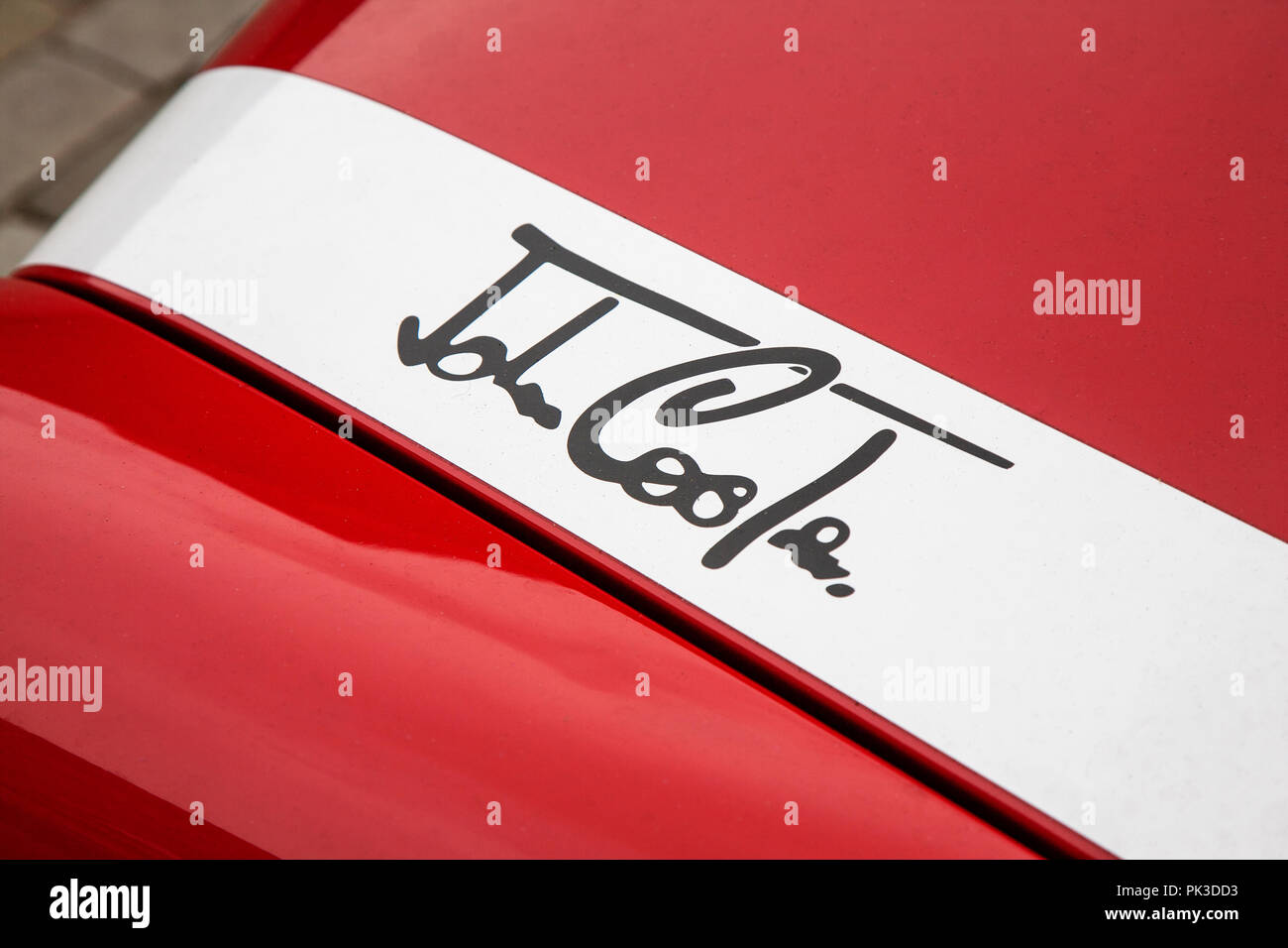 The John Cooper Logo Badge On The Bonnet Of A Red Mini Cooper John