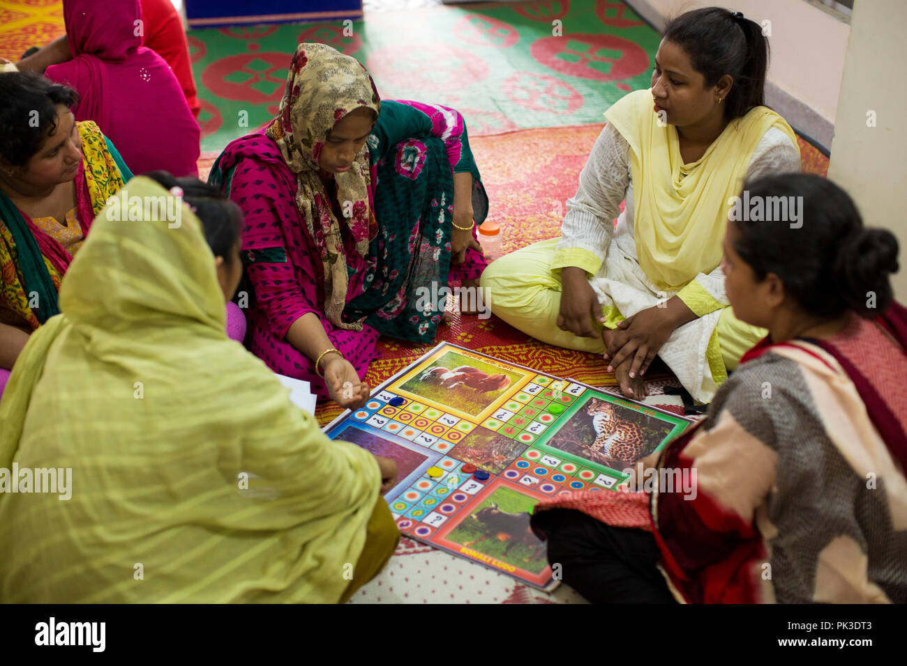 Women playing a board game during a workshop in Dhaka, Bangladesh. Stock Photo
