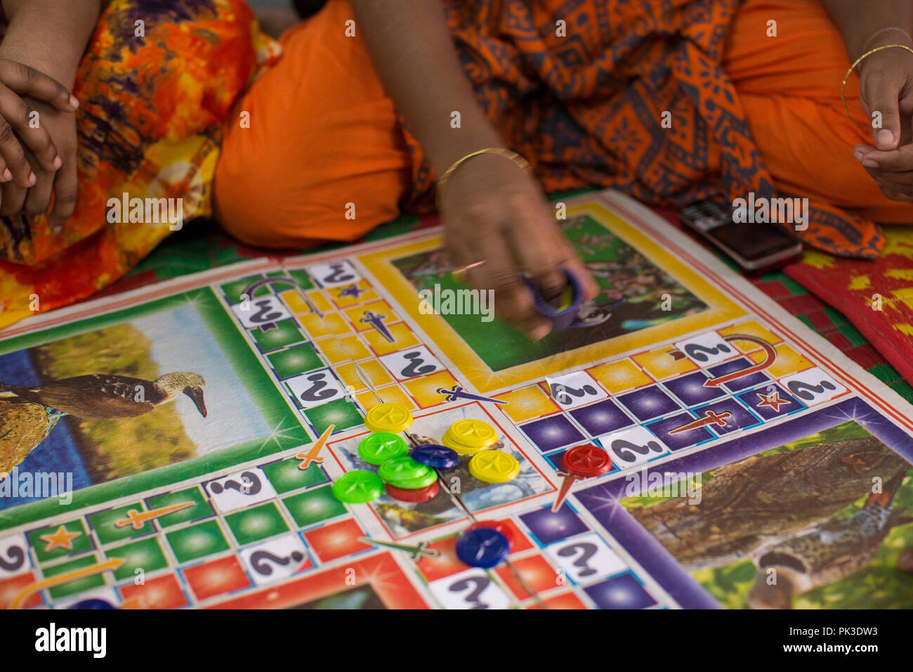 A close of a woman rolling a dice during a board game, Dhaka, Bangladesh. Stock Photo