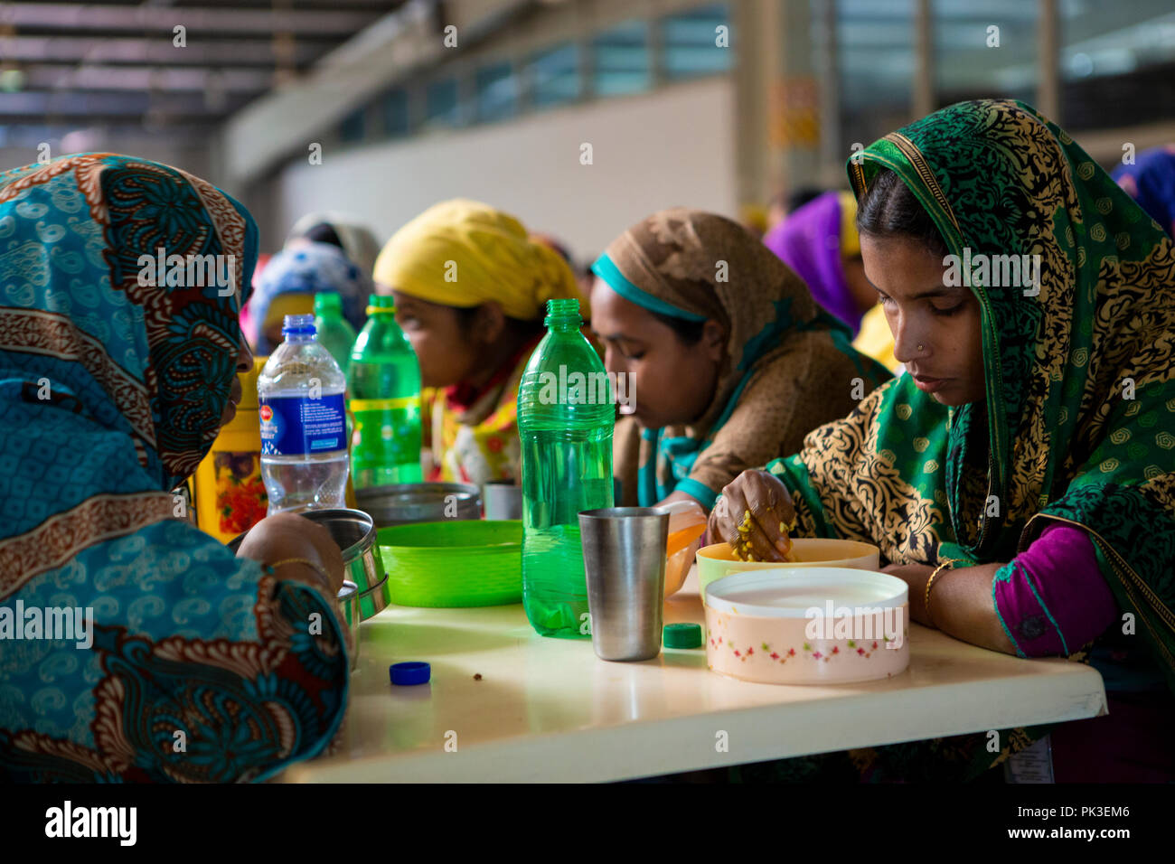 Garment workers having their lunch in the canteen at a garment factory