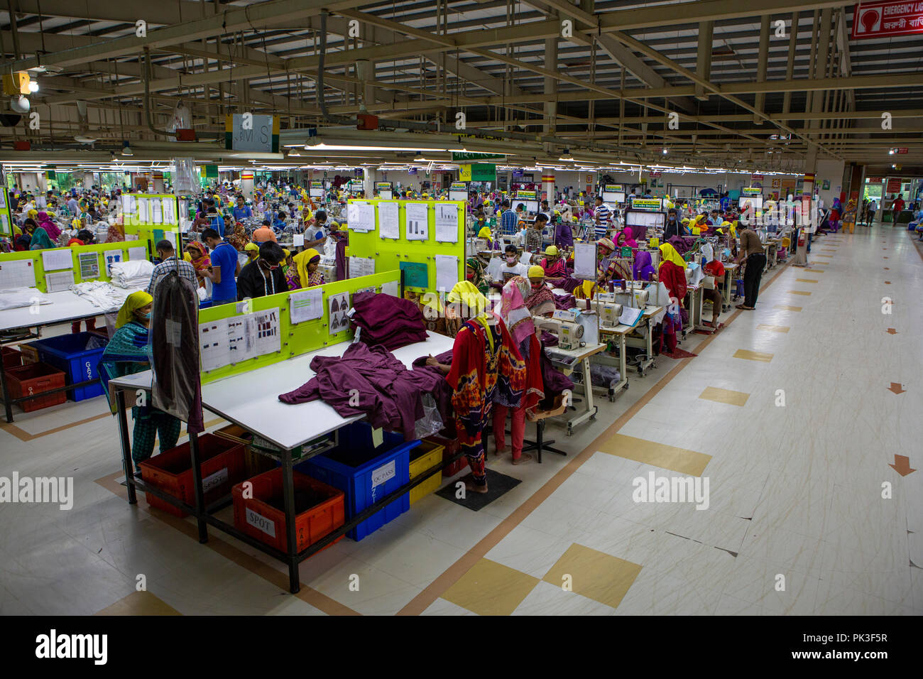 Garment workers working inside a garment factory in Bangladesh. Stock Photo