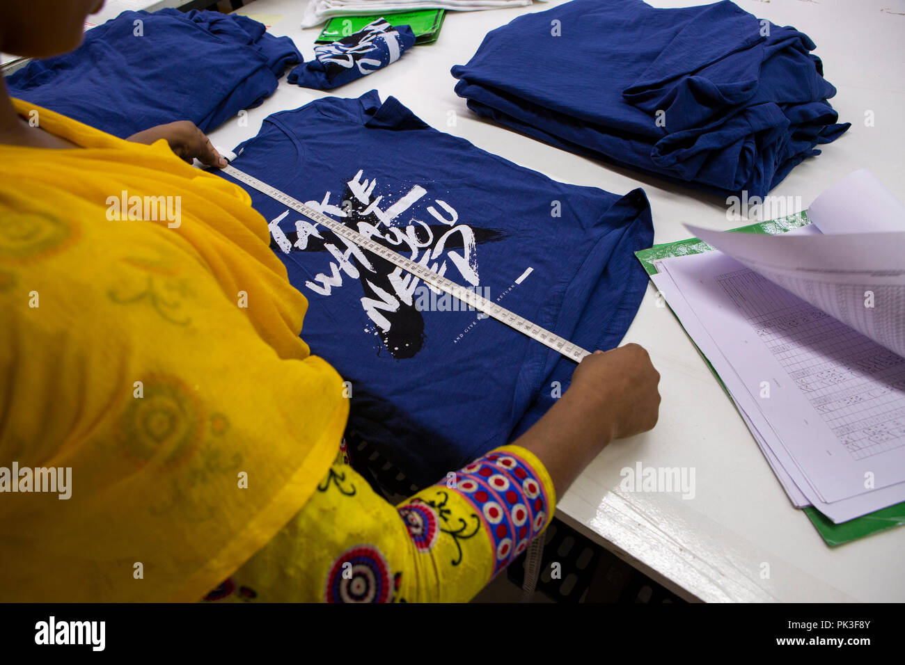 Clothes being measured and checked inside a garment factory in ...