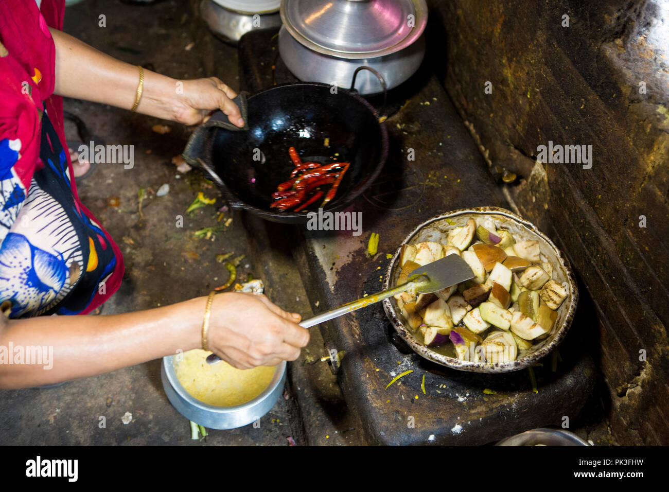 Curry being cooked in a communal kitchen where lots of garment workers