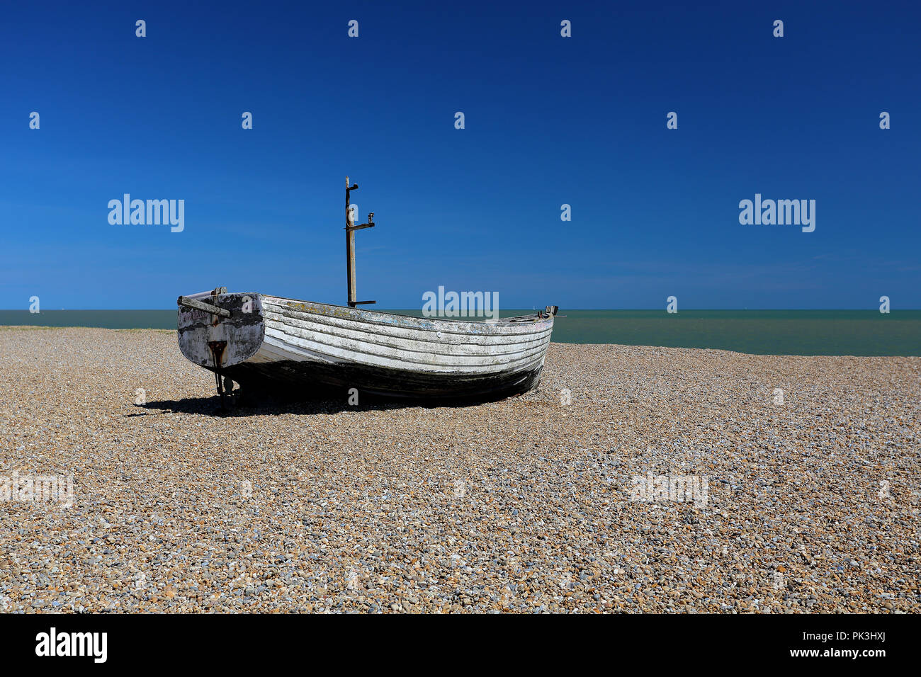 A boat beached on the shingle beach at Aldeburgh, Suffolk, UK Stock ...