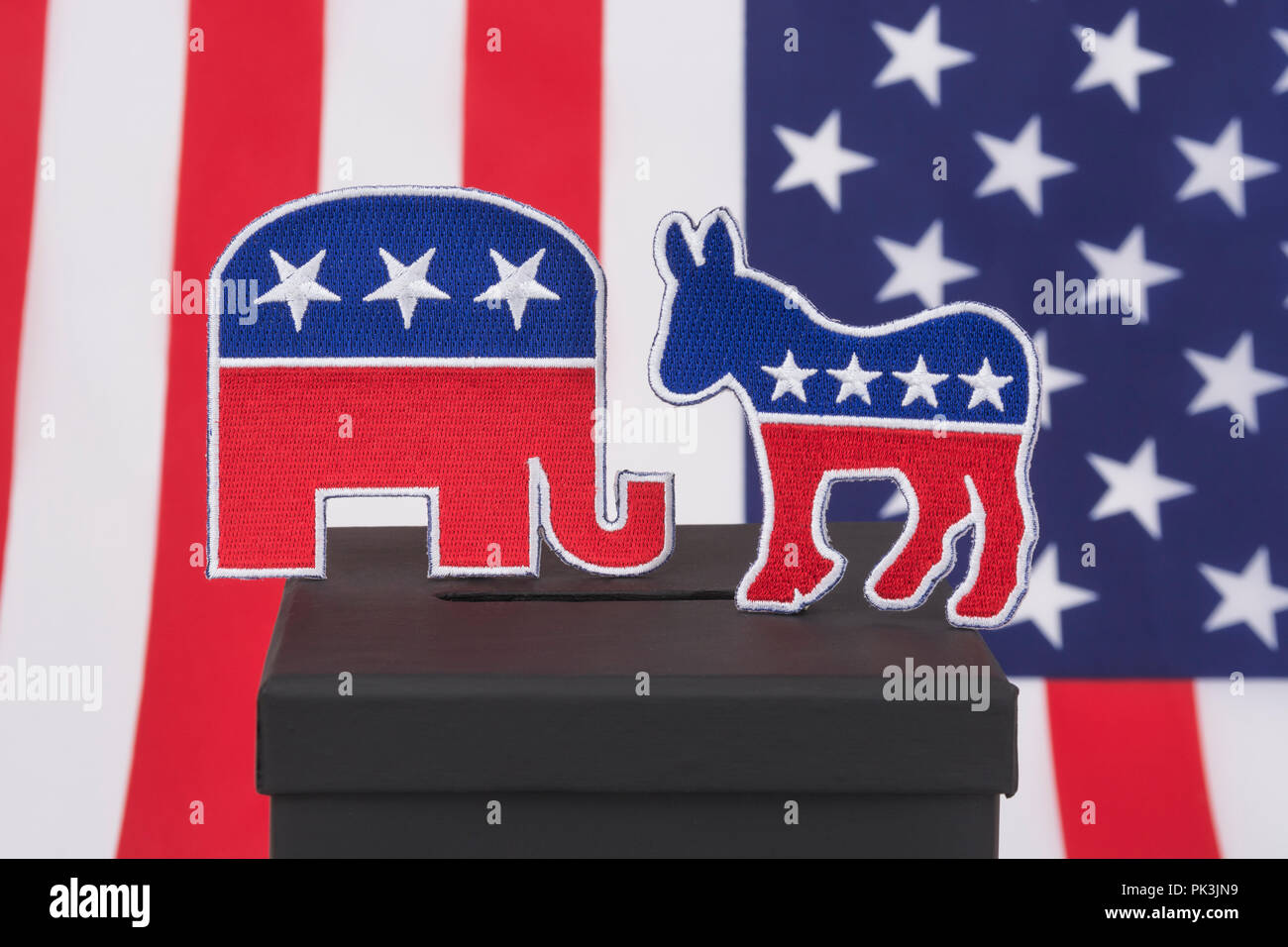 2024 US Presidential Election / Midterm election America 2022. GOP / Republican elephant & Democratic Donkey logos (patch) & ballot box, election USA Stock Photo
