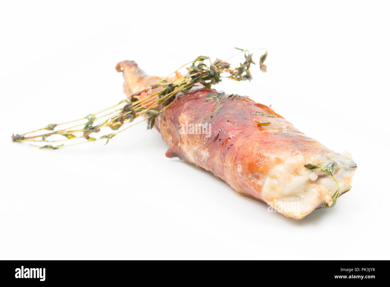 Two mackerel fillets, Scomber scombrus, that have had Parmesan cheese placed between them before being wrapped in Parma ham and then fried in butter a Stock Photo