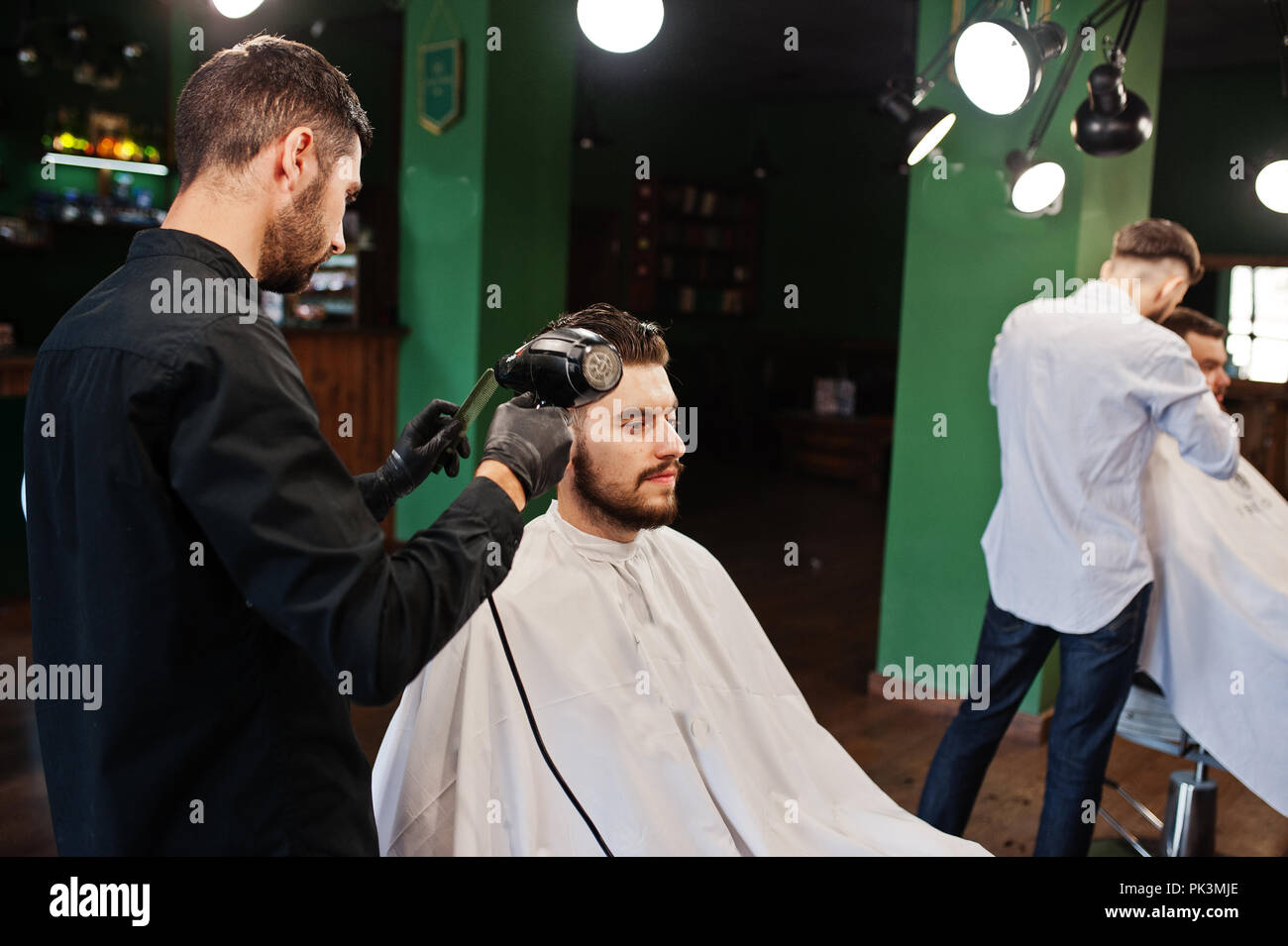 Barber shop using hair dryer hi-res stock photography and images - Alamy