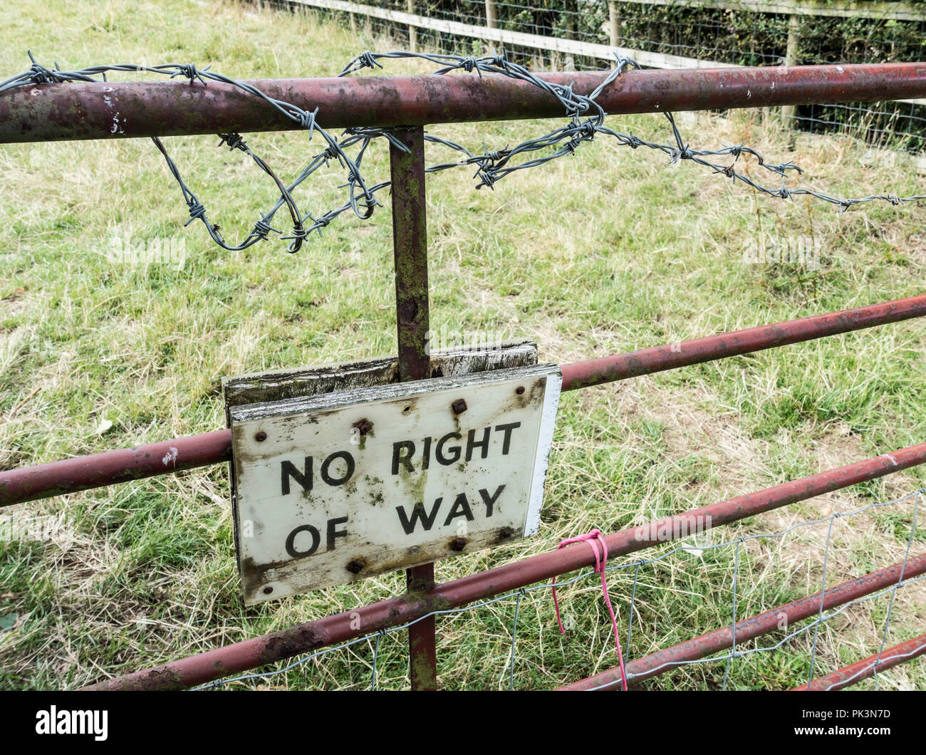 No right of way sign below barbed wire on farm gate in countryside. England. UK Stock Photo