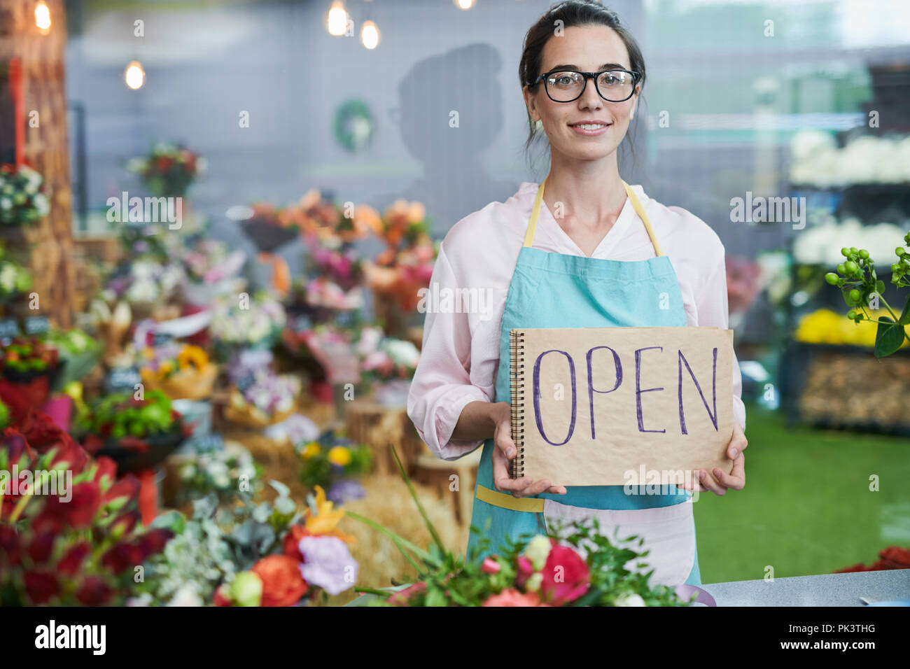 Shopkeeper Holding OPEN Sign Stock Photo
