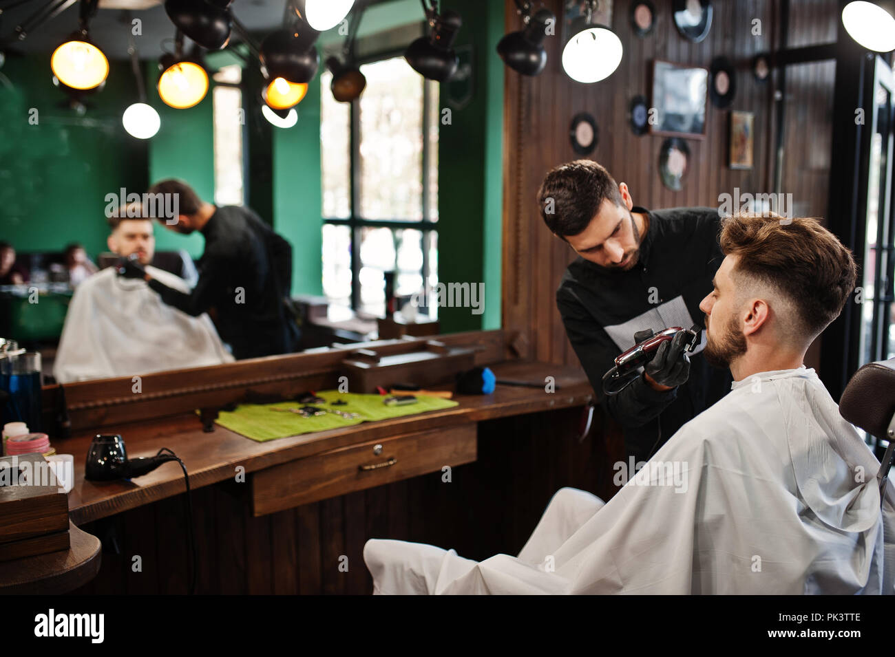 Handsome bearded man at the barbershop, barber at work Stock Photo - Alamy