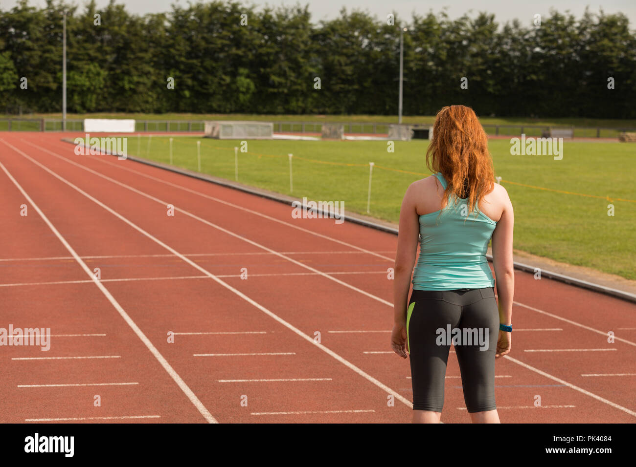 Female athlete standing on sports track Stock Photo