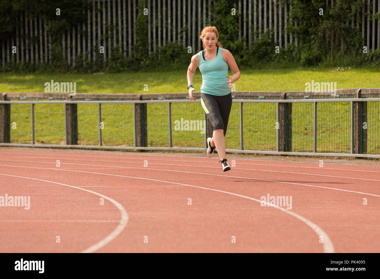 Female athletic running on sports track Stock Photo Alamy