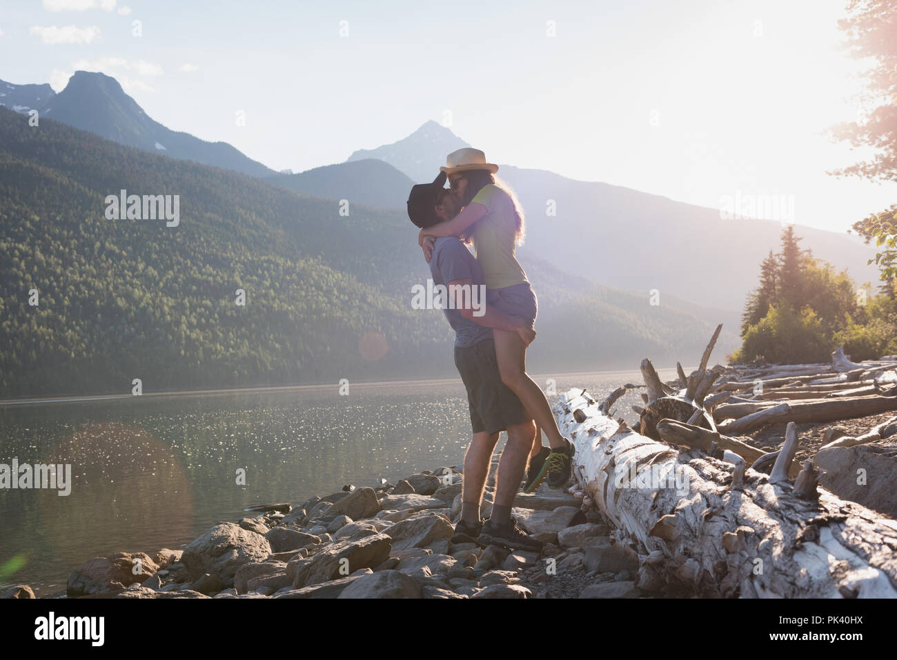 Couple kissing each other near riverside Stock Photo