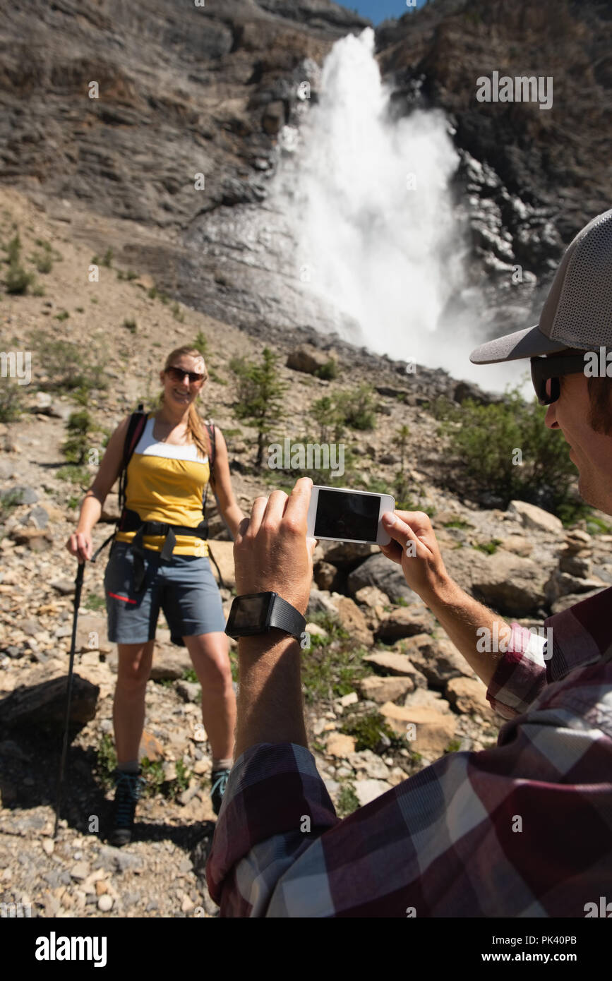 Man clicking photo ow woman with mobile phone Stock Photo