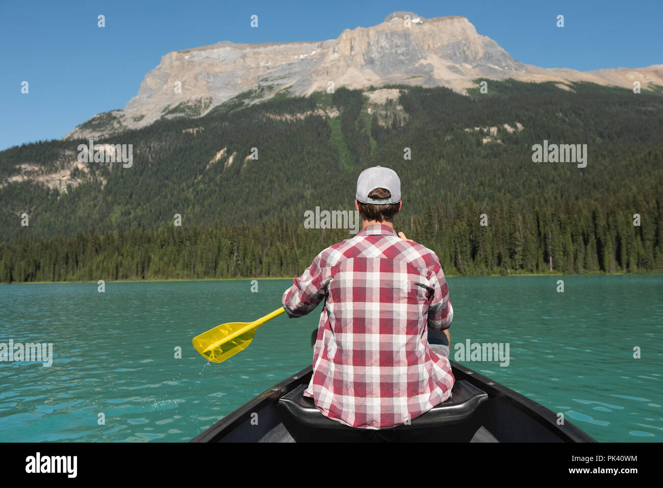 Man rowing a boat in river at countryside Stock Photo