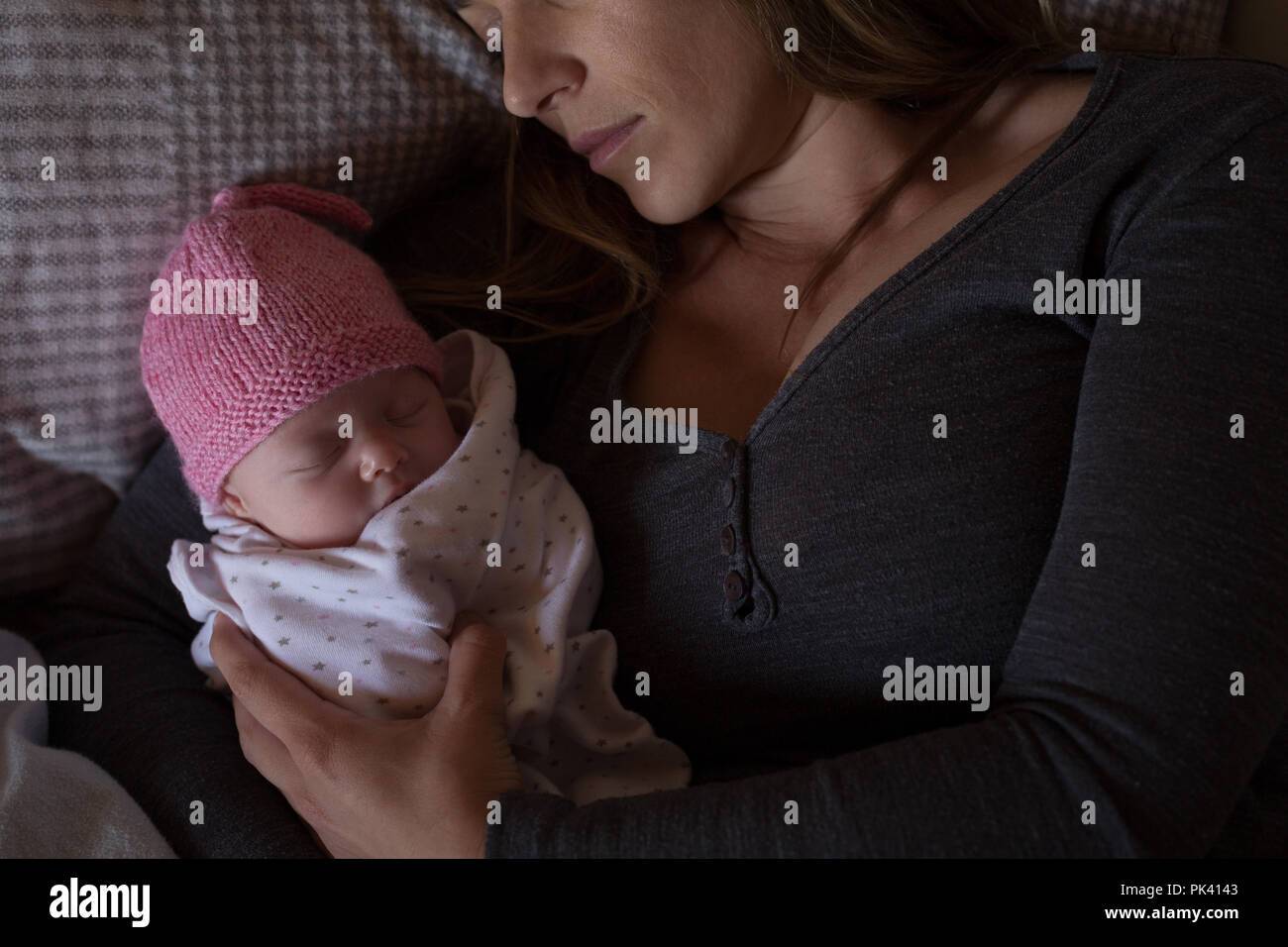 Mother with baby relaxing on bed at home Stock Photo