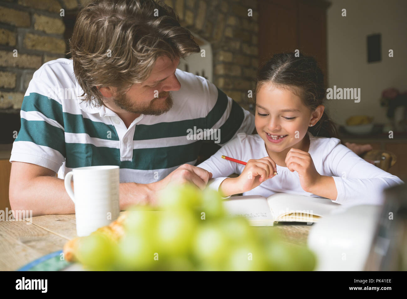 Father helping her daughter in studies Stock Photo