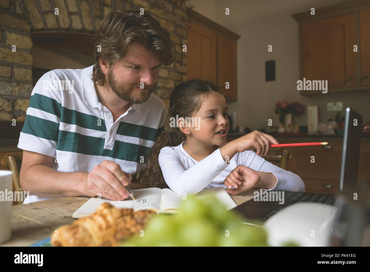 Father and daughter using laptop Stock Photo