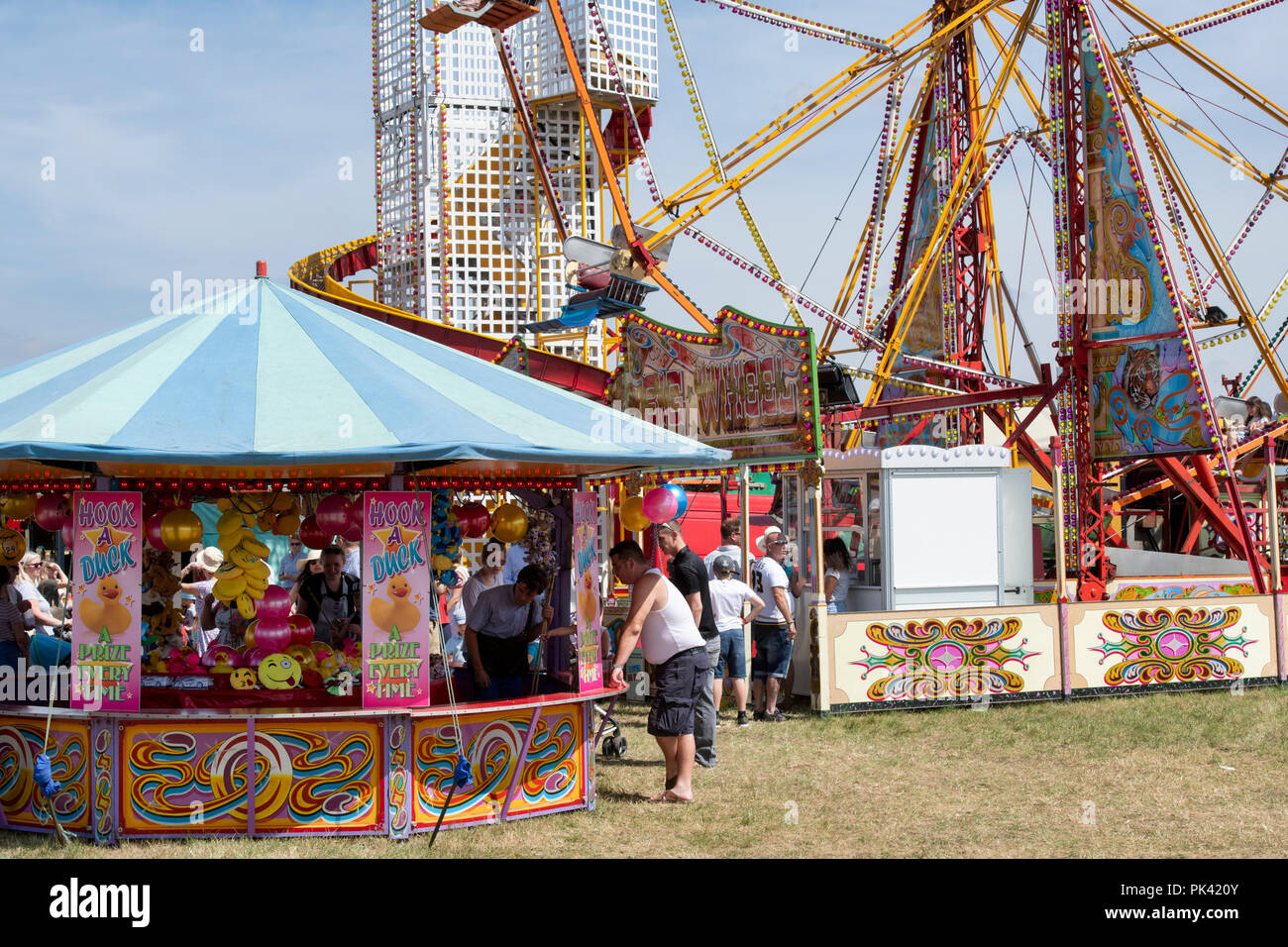 Hook a duck stall and big wheel at a vintage steam fair in England Stock Photo