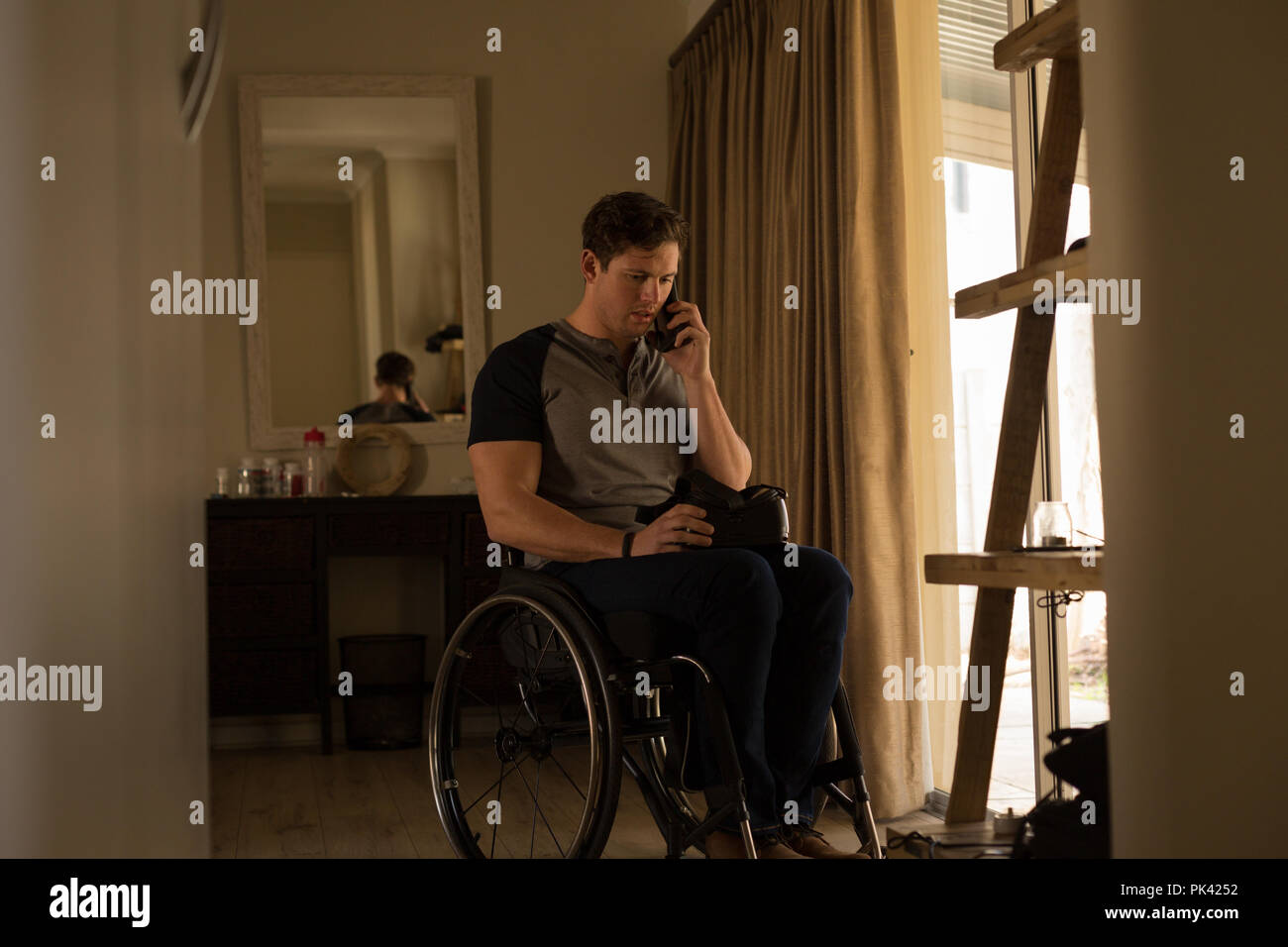 Disabled man talking on mobile phone Stock Photo