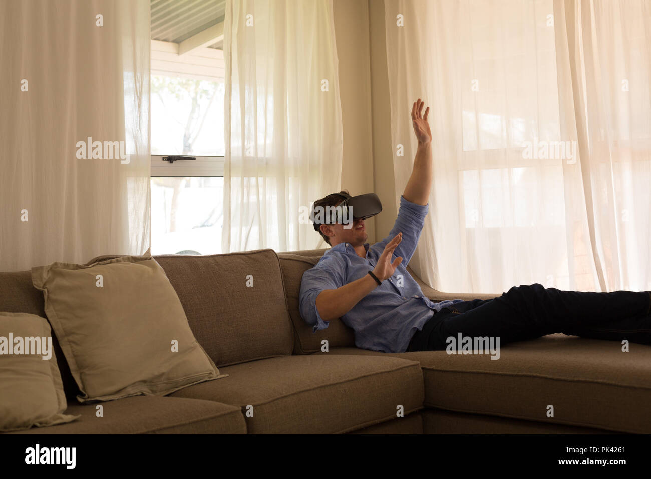 Disabled man using virtual reality headset in living room Stock Photo Alamy