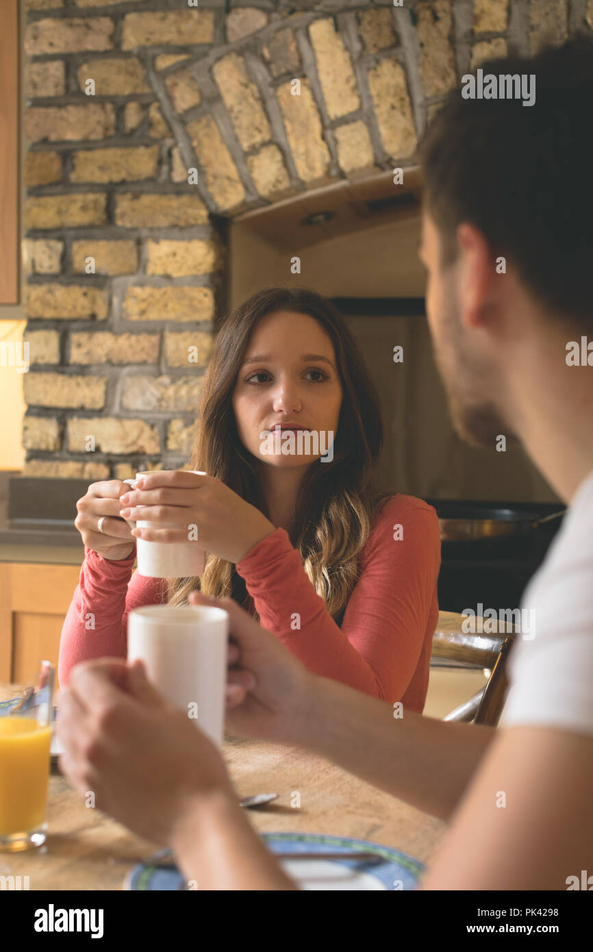 Couple interacting with each other while having coffee Stock Photo