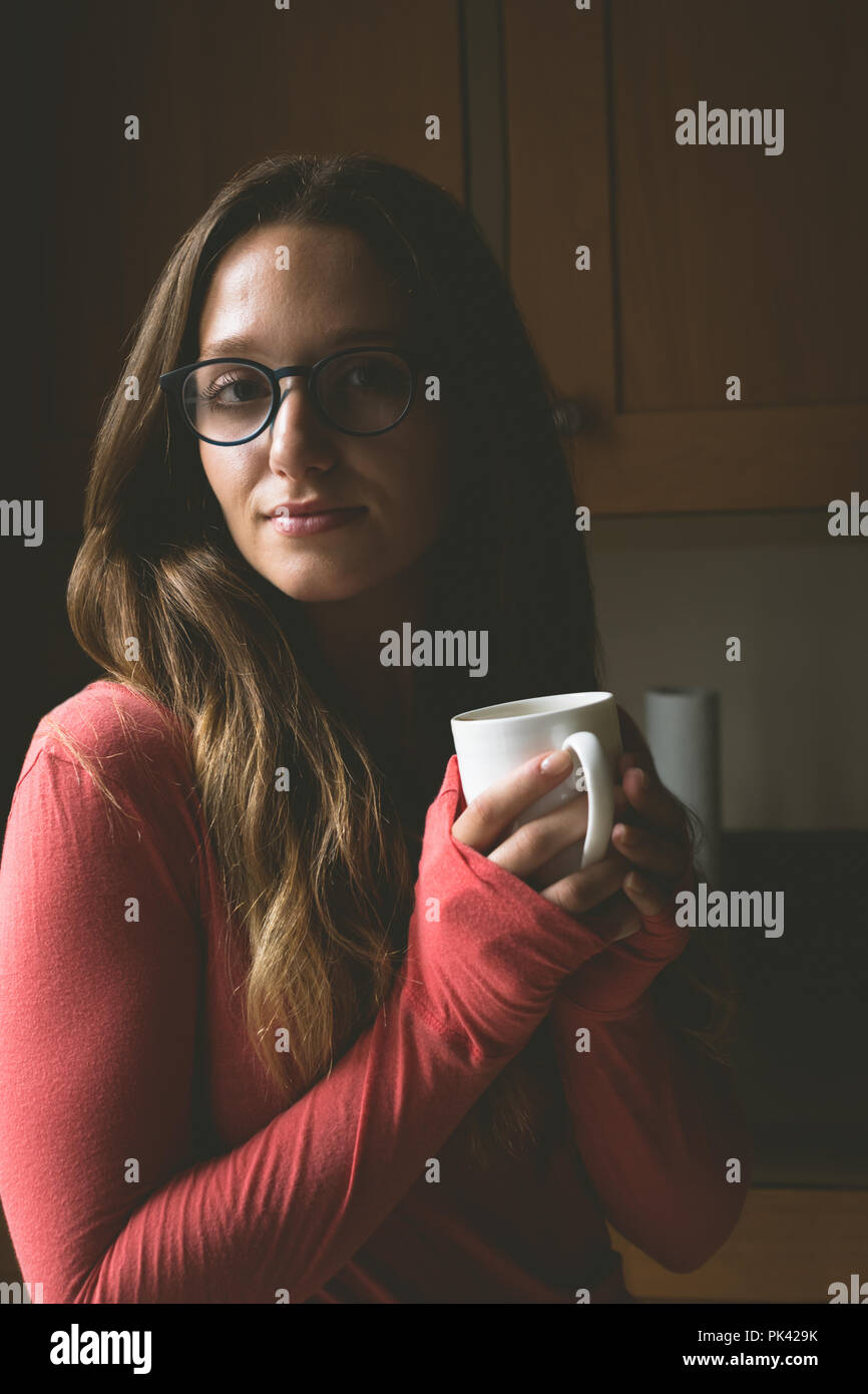 Woman having coffee at home Stock Photo