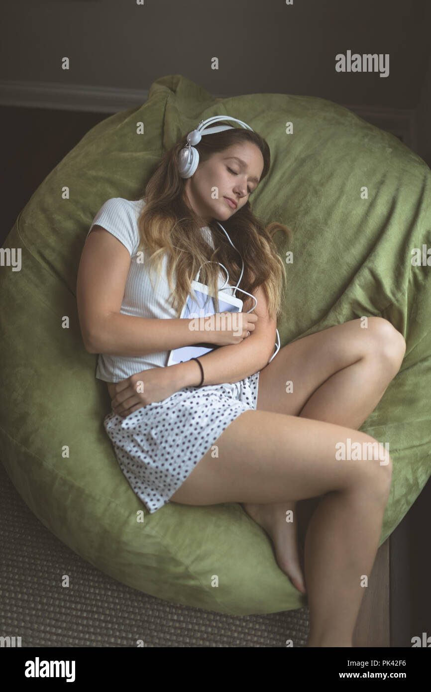 Woman listening music on headphones while sleeping Stock Photo Alamy