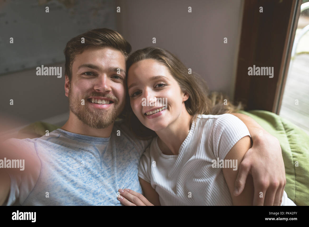 Couple sitting together with arm around Stock Photo